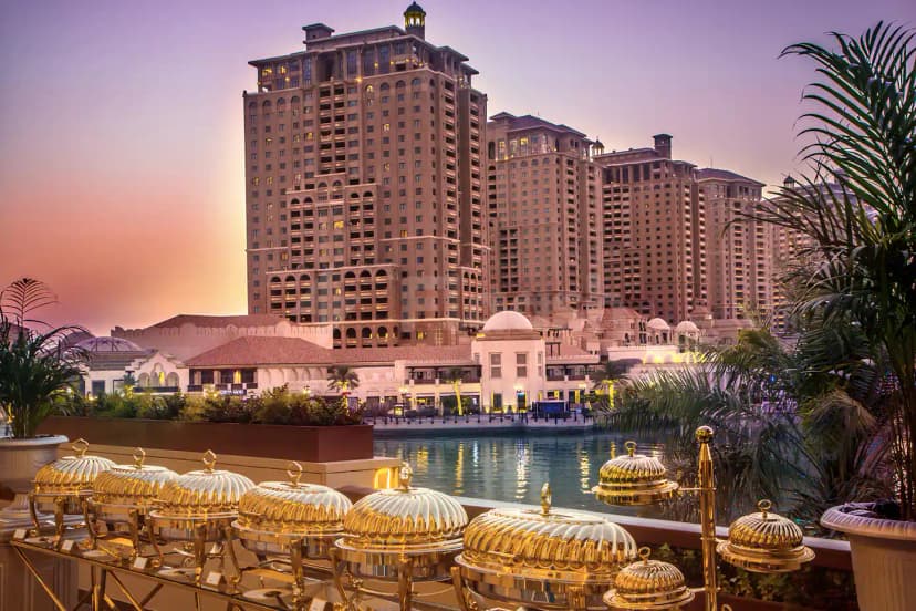 Rooftop terrace at White Palace Wedding Hall in Doha with canal view and golden chafing dishes
