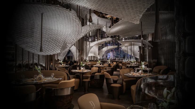 Sculptural white ceiling installation dominates Doors Dubai Mall Restaurant in Dubai, with round dining tables and pendant lighting