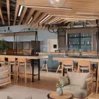Restaurant at Rove Expo 2020 Dubai featuring an open-plan layout with wooden ceiling beams and pendant lighting