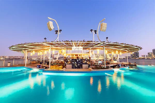 Rooftop terrace at Cafe del Mar Beach Club Abu Dhabi with infinity pool and circular bar