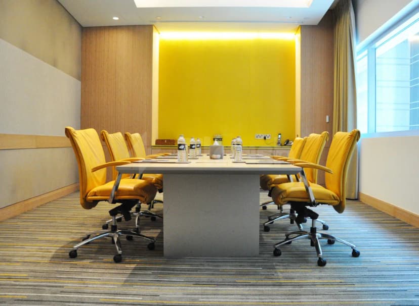 Boardroom at Mosaic Pool Lounge & Bar Downtown Dubai featuring a long rectangular table, yellow leather chairs