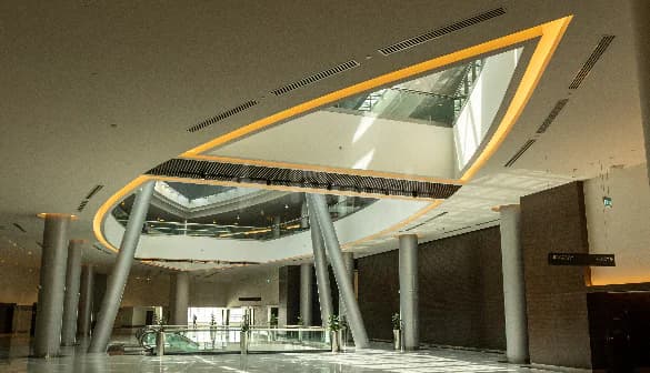 Entrance Hall at Jafza One Convention Centre in Dubai featuring a curved yellow lighting feature and glass skylight