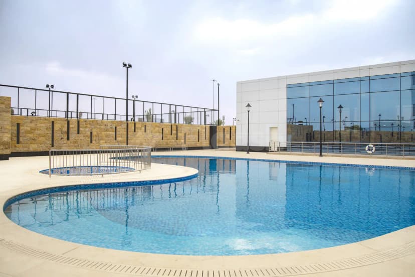 Swimming pool at Cristal Amaken Hotel Riyadh featuring a circular inset pool and stainless steel railing