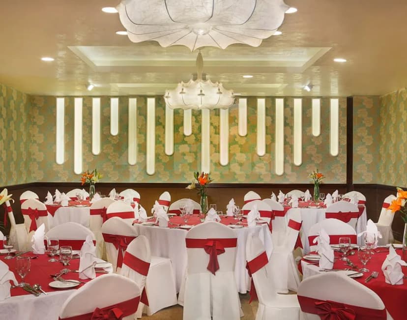 Ballroom at City Seasons Al Hamra Hotel in Abu Dhabi with vertical light panels on floral wallpaper