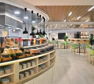 Buffet counter at Swissotel Al Murooj Dubai in Dubai with curved wooden shelving