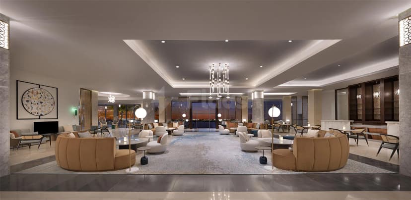Large open lobby at Kempinski Sariya in Yanbu featuring beige velvet sofas, a modern chandelier, and marble columns