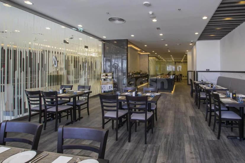 Restaurant at TIME Onyx Hotel Apartments in Dubai with glass partition wall featuring vertical frosted strips