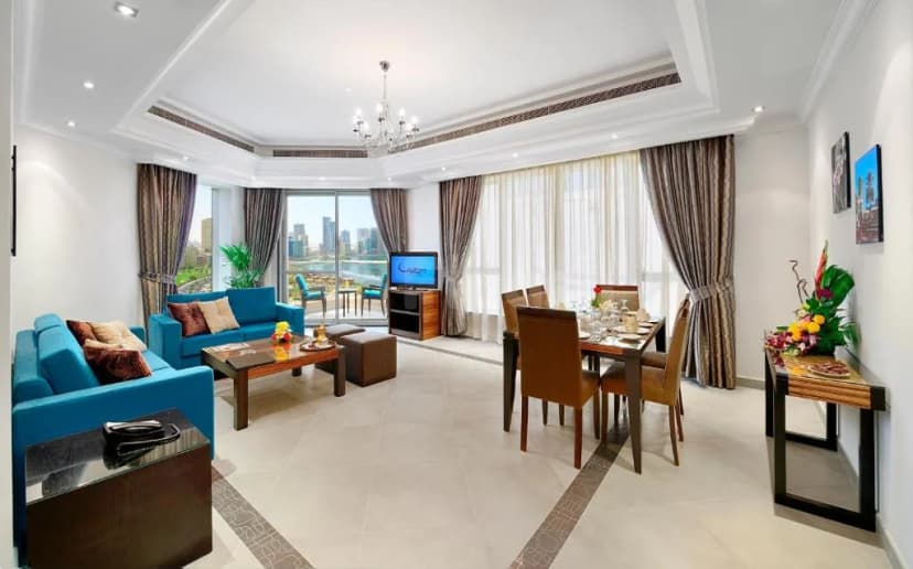 Dining area at Al Majaz Premiere Hotel Apartments in Sharjah with city and river view through large windows