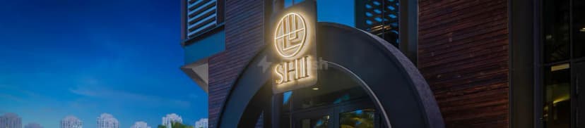 Hotel facade of Shi Restaurant Dubai Marina featuring an illuminated sign and dark metal archway against a blue