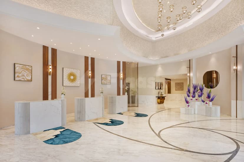 Entrance hall of Blooms Ava Restaurant in Dubai featuring white marble reception desks, ornate ceiling relief, and circular
