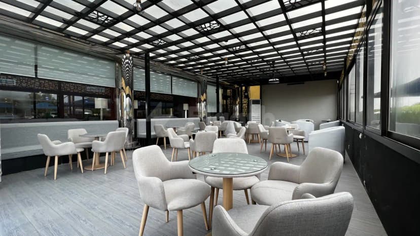 Rooftop terrace at Crown Tower Al Jubail featuring a black metal ceiling grid with translucent panels and modern