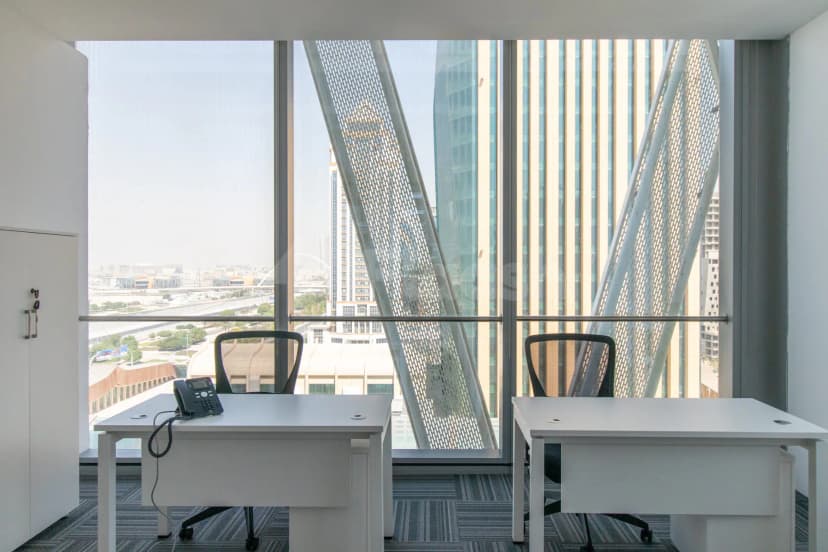 Meeting room at Hub Business Center Burj Marina Lusail with large windows, perforated metal screens, and city view