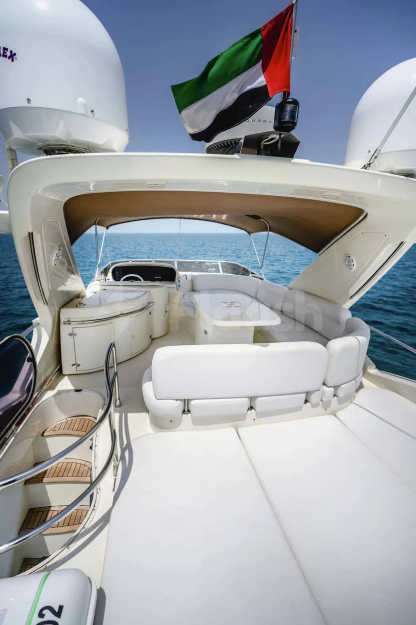 Azimut 62 Lucky Star Yacht Dubai open-air deck with white leather seating, brown canopy, and UAE flag against