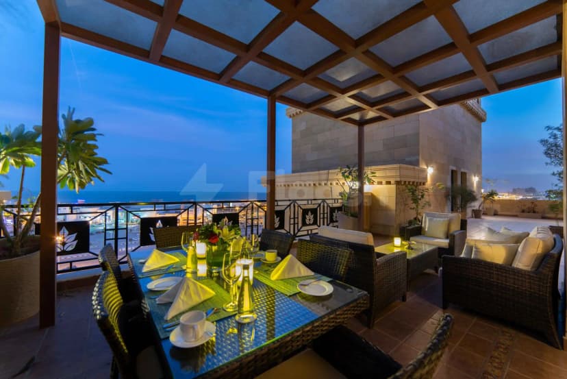 Rooftop terrace at Warwick Al Khobar in Al Khobar with wooden pergola ceiling and sea view