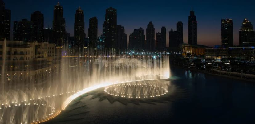 Rooftop terrace at Armani Hotel Dubai with illuminated circular water fountain and backdrop of Burj Khalifa and Dubai’s