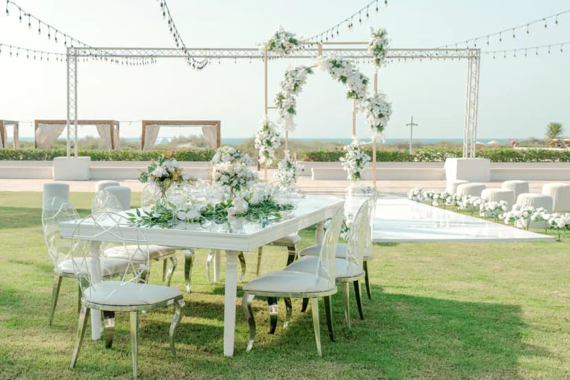 Terrace at Saadiyat Beach Club in Abu Dhabi featuring a white flower arch, metal truss structure, and sea