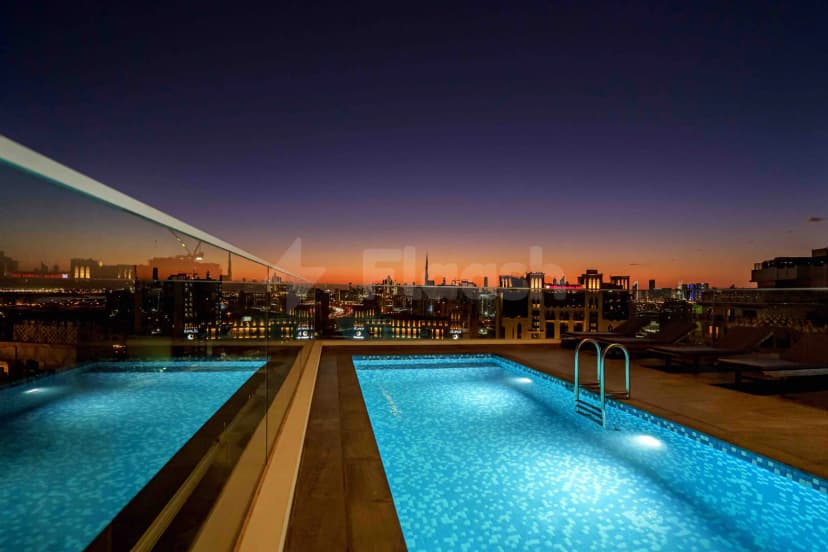 Rooftop terrace at Form Hotel Dubai in Dubai with illuminated pool and city skyline view
