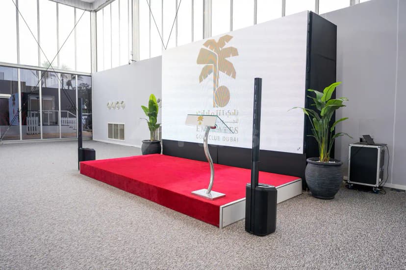 Ballroom at Emirates Golf Club Dubai featuring a red carpet stage and large LED screen displaying the club