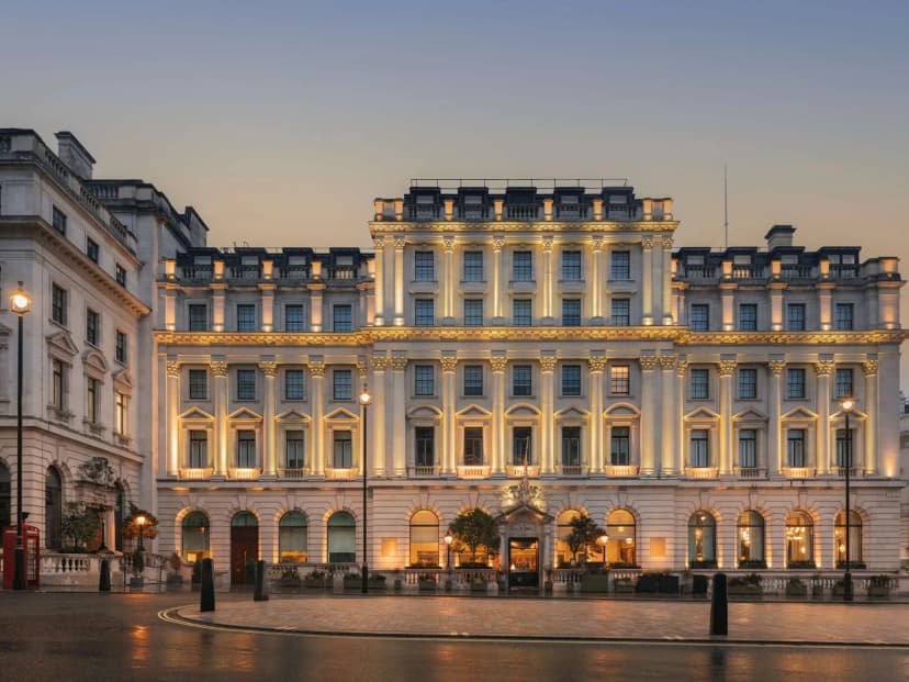 Illuminated facade of Sofitel London St James at dusk.